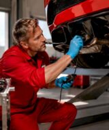 Technician diagnosing supercar exhaust sound issue