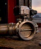 Close-up of butterfly valve in exhaust pipe on workbench