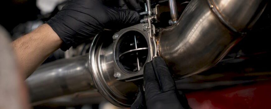 Technician adjusting valved exhaust component