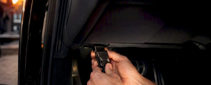 Hands plugging OBD valve controller module