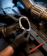 Technician checking exhaust sensor fitment