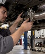 Technician inspecting a valved exhaust assembly
