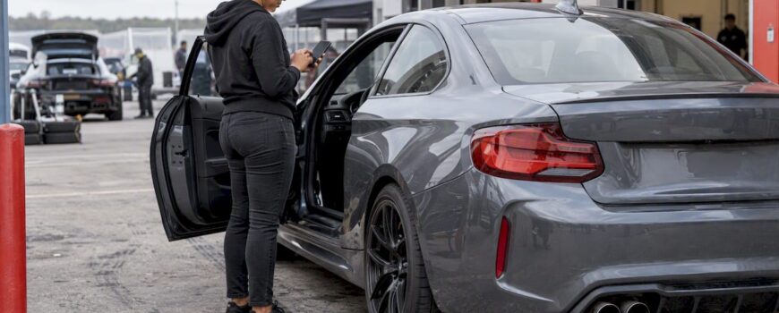 Driver sets exhaust valves beside performance coupe